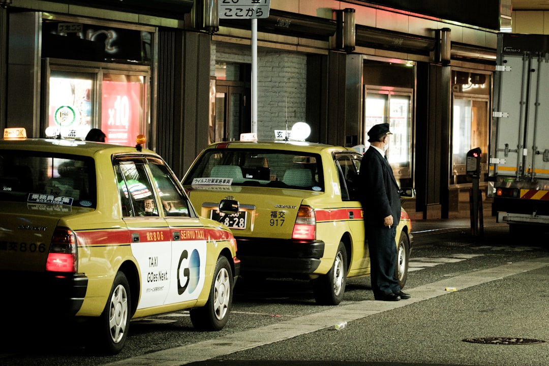 a person standing next to a yellow car