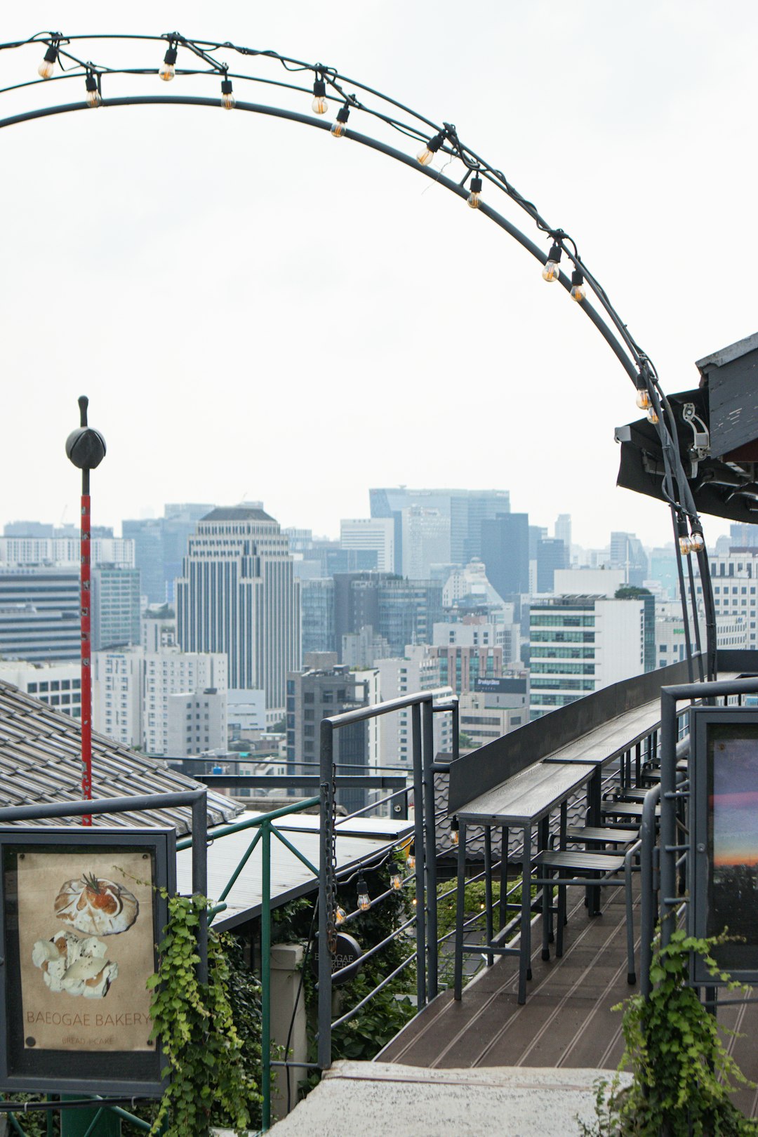 City skyline viewed from a rooftop with arched lights