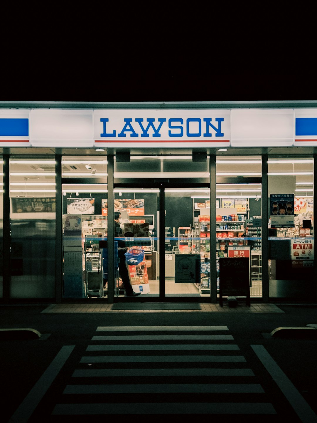 Lawson convenience store at night with illuminated entrance