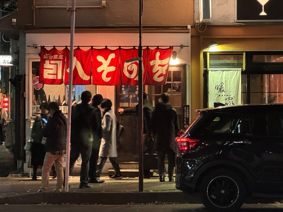 A group of people standing outside of a building at night