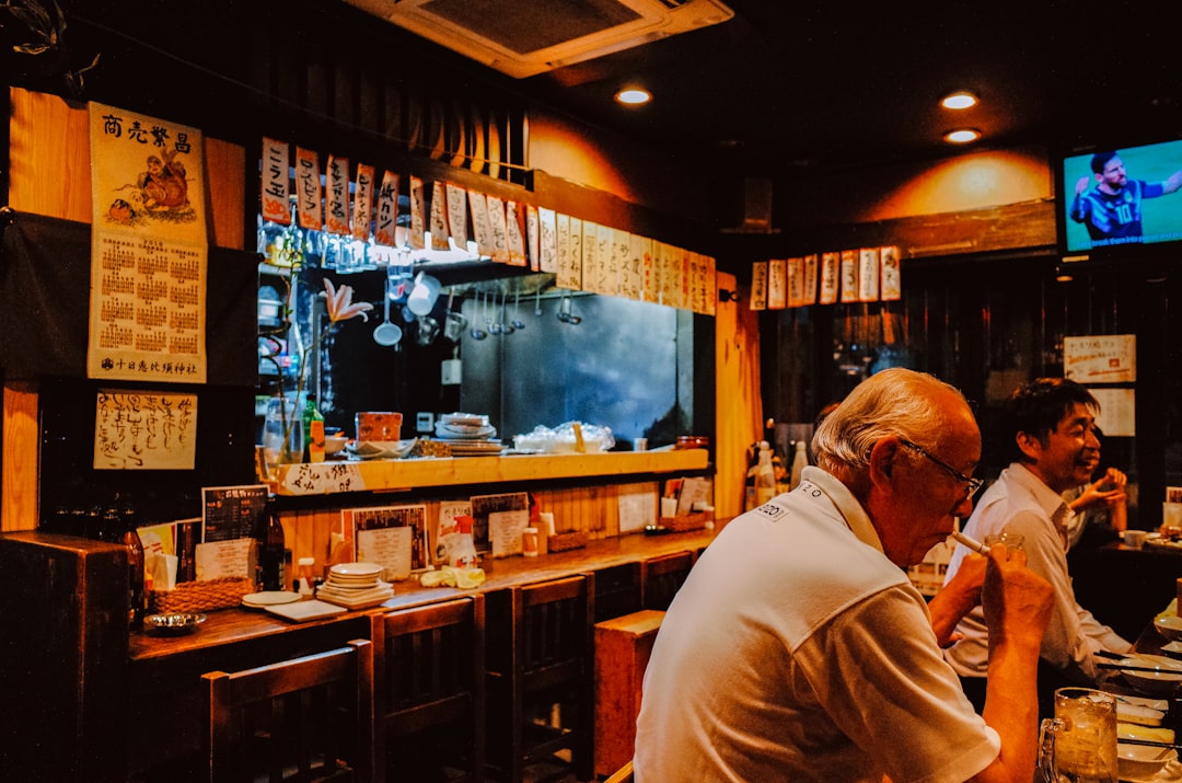 People sitting at a bar in a dimly lit restaurant