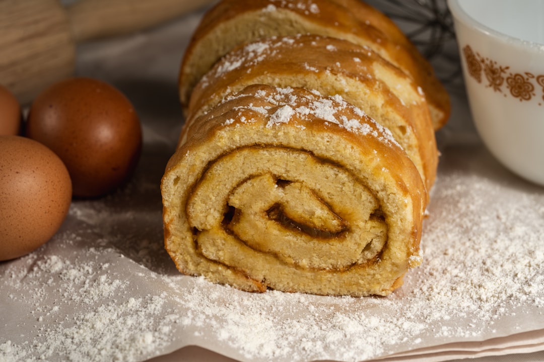 A sliced swiss roll cake with eggs and flour