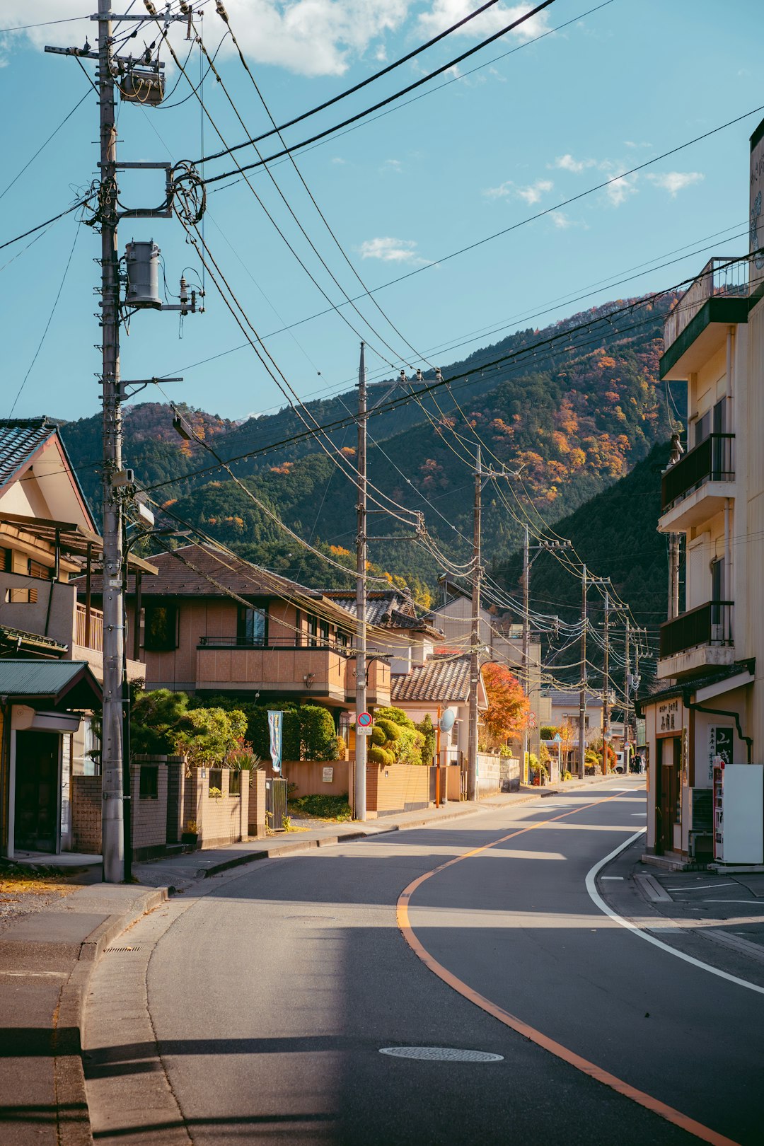 An empty street with a mountain in the background