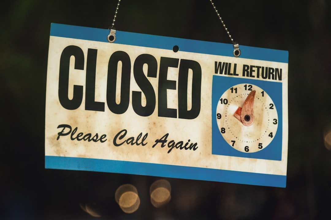 a close up of a sign with a clock on it