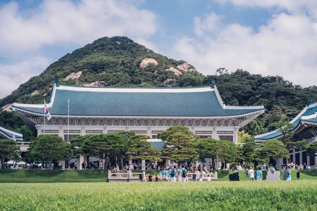 Blue-roofed building with a mountain behind it