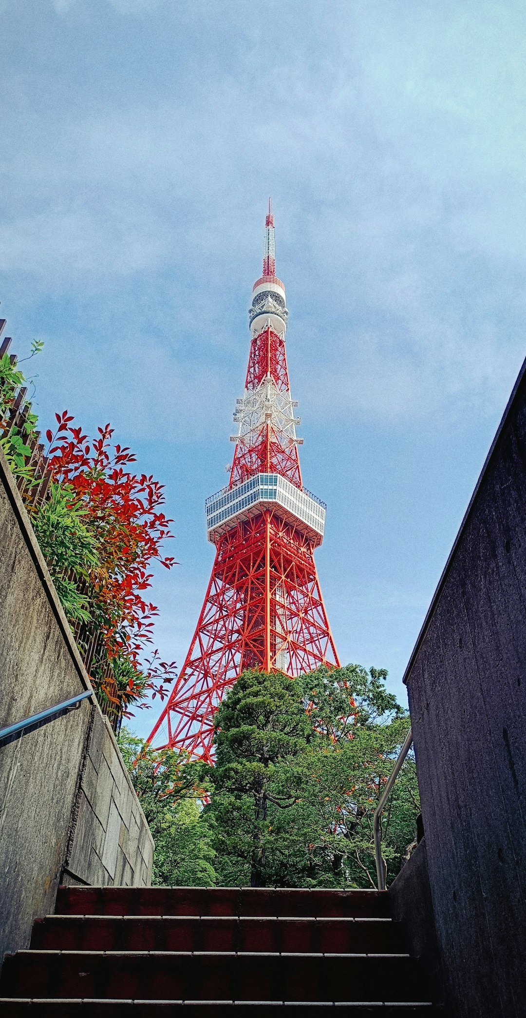 a very tall red tower towering over a city
