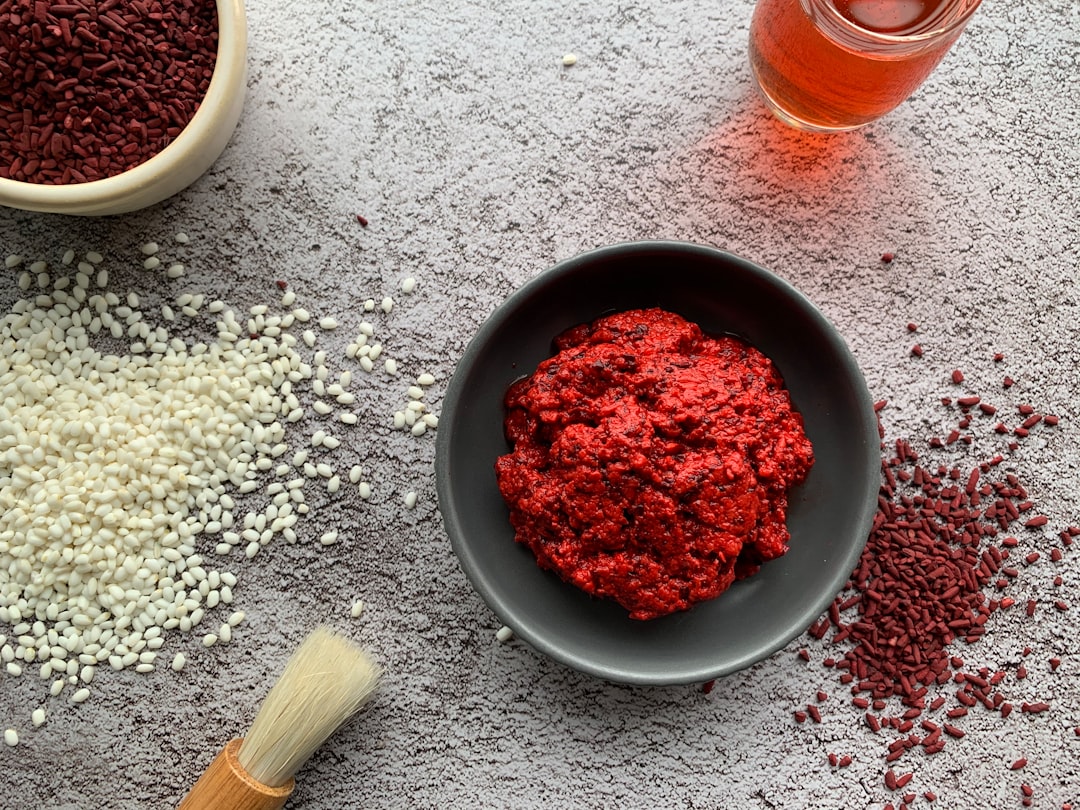 red powder in black round bowl