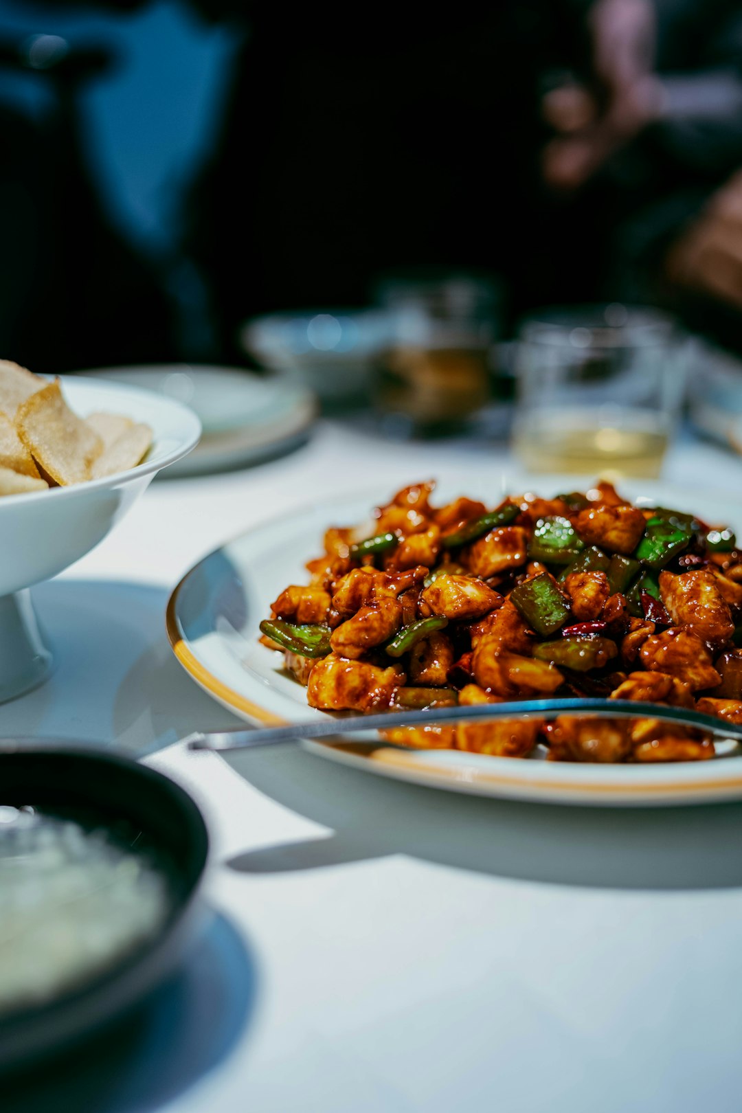 A plate of glistening chicken and green peppers