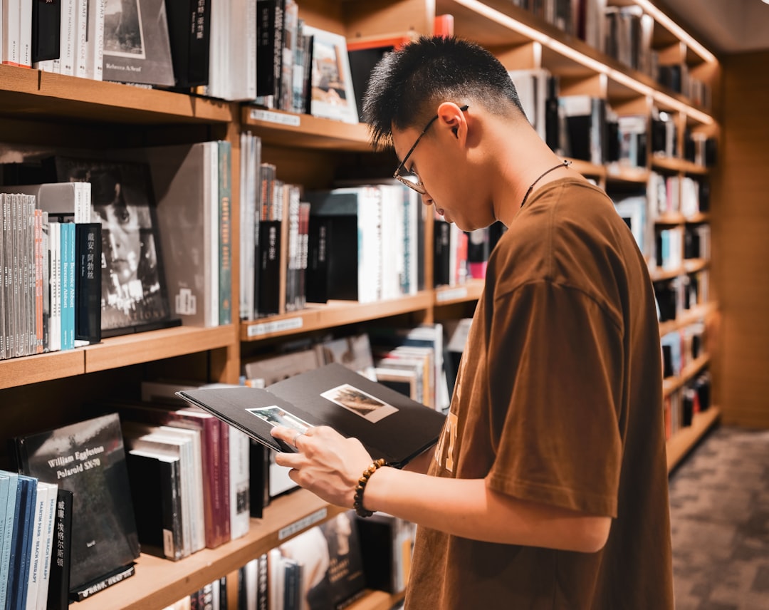 a man reading a book in a library