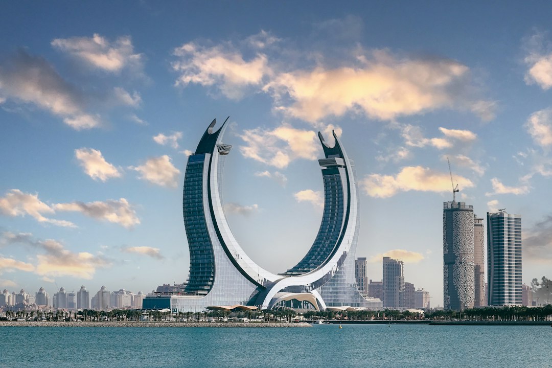The crescent-shaped Katara Towers rising above the waterfront in Lusail, Qatar