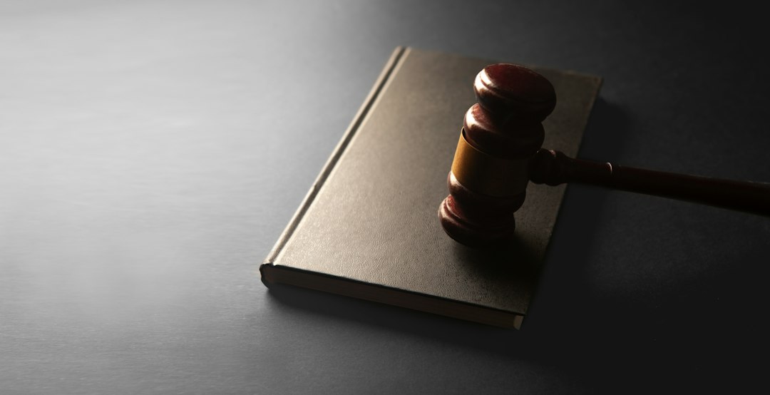 A wooden gavel rests on a closed book